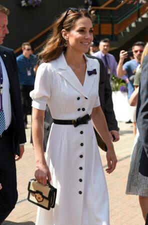 A white shirtdress by Suzannah featuring black button