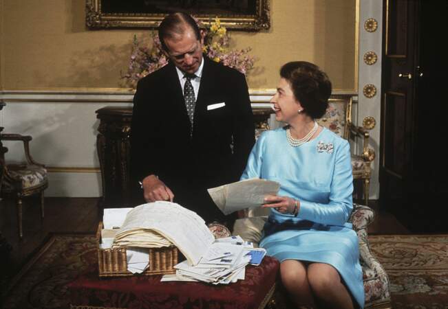 1972: Queen Elizabeth and Prince Philip sort through a basket of mail 